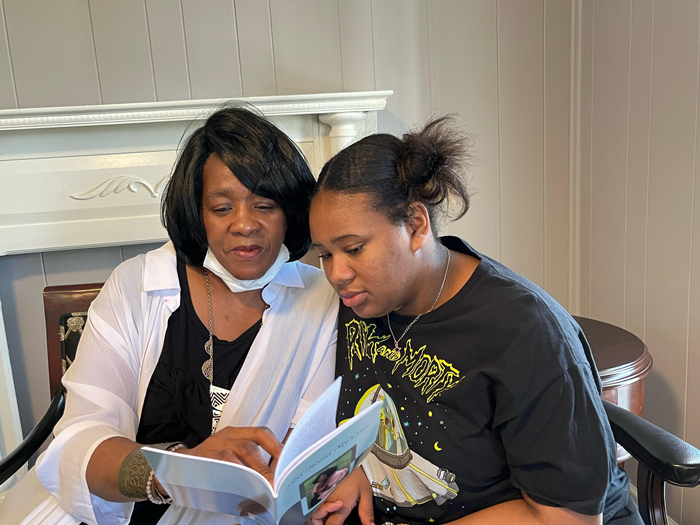 woman-and-her-daughter-looking-at-a-book